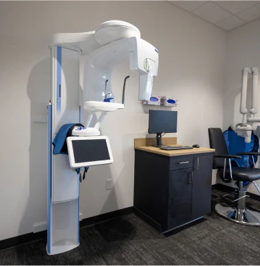 Pediatric dental X-ray machine setup in modern exam room.