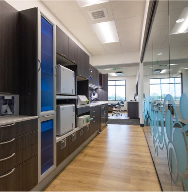 Dental office sterilization hallway with modern cabinetry and equipment
